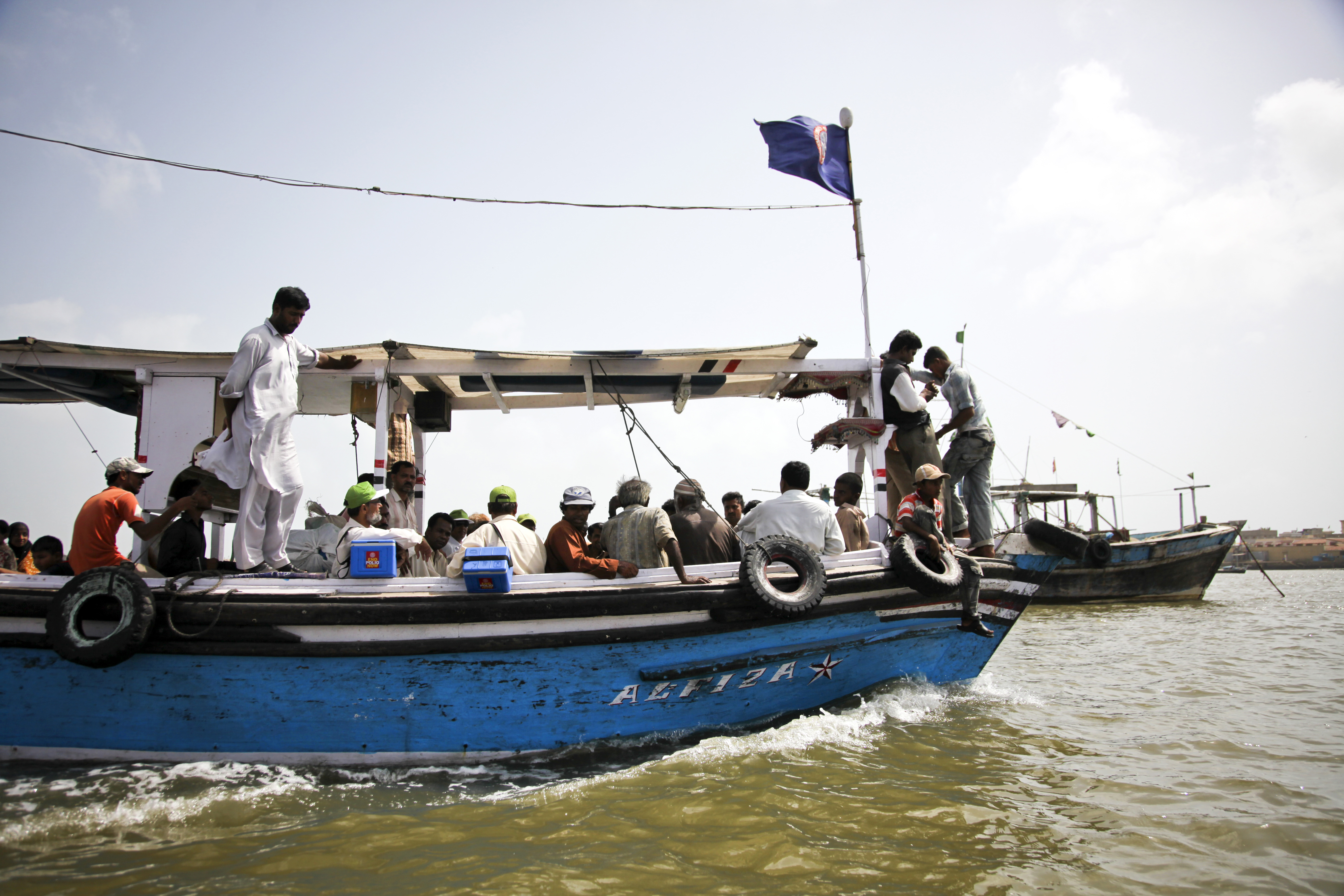 In Pakistan, one of the last three countries where the wild polio virus is endemic, Rotary health workers (in green caps) travel by boat to immunize the children of Karachi’s Bath Island. Since Rotary, UNICEF’s partner in the Global Polio Eradication Init