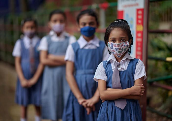 A group portrait of students wearing masks at Gandaria Mohila Shomity Government Primary School, Dhaka, Bangladesh on September 2021.