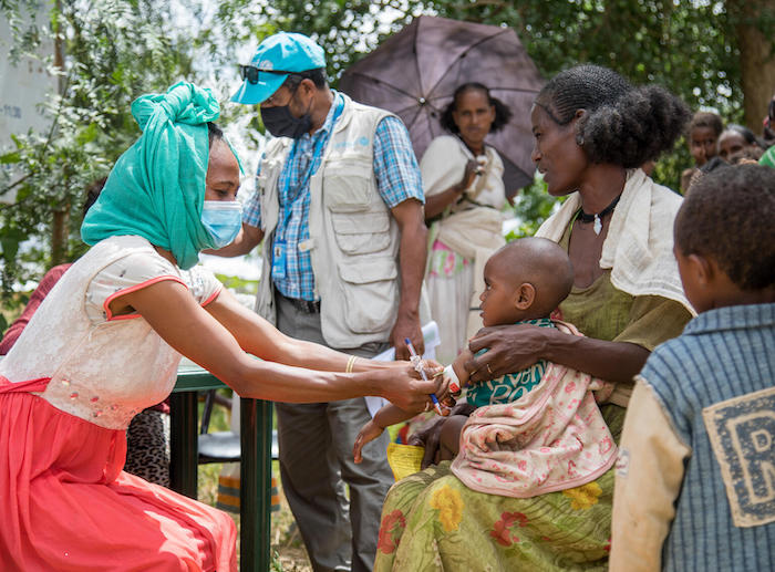A UNICEF-supported health worker checks a child for malnutrition at a health center in Abi Adi in central Tigray, Ethiopia.
