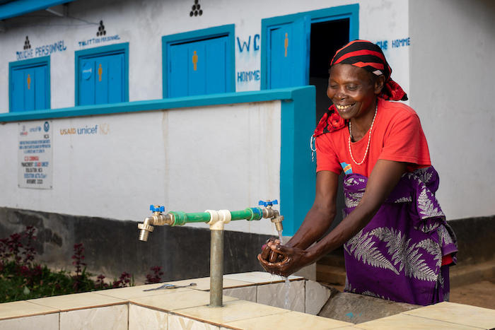 A woman washes her hands at a water point built by UNICEF at Cibingu health center near Bukavu, South Kivu province, Democratic Republic of the Congo.