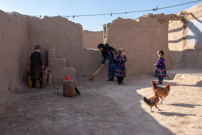 Parwana, 4, center, at home with her mother and brother in Herat, Afghanistan.