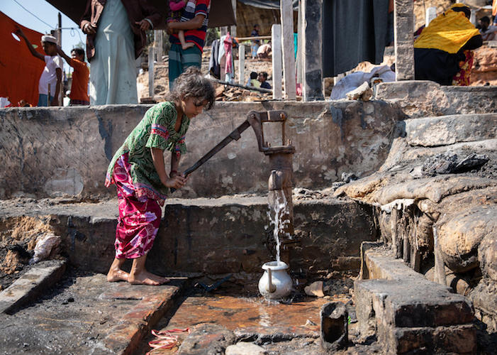 A girl uses an old hand-pump tube-well for water at a Rohingya refugee camp in Cox's Bazar, Bangladesh. 