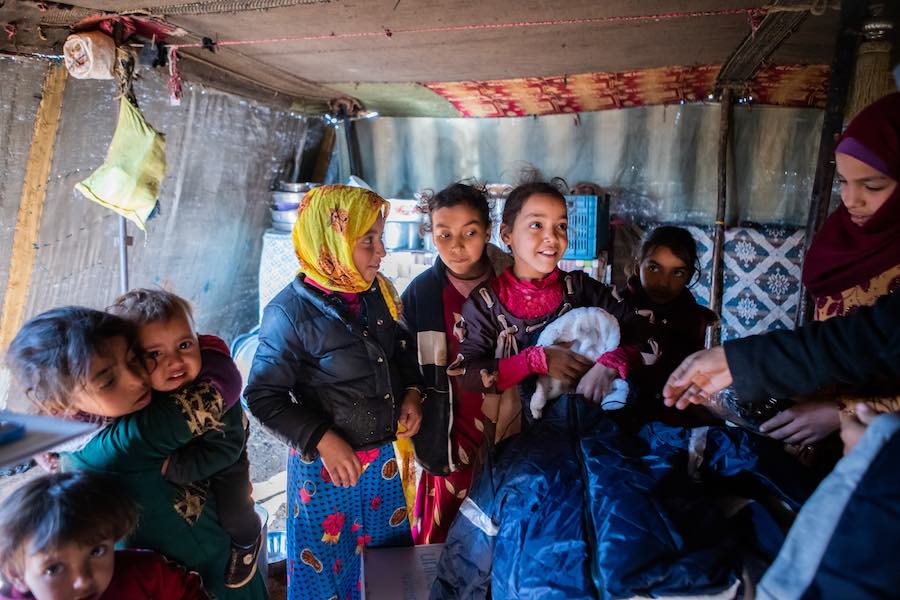 UNICEF helps parents who can't afford food and clothing by delivering supplies to temporary settlements in Syria.
