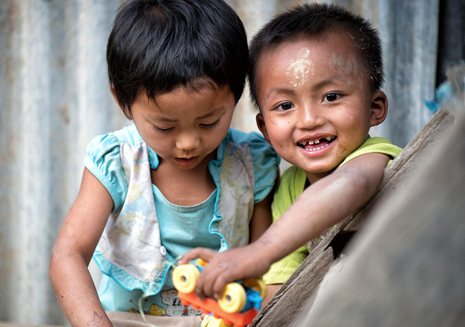 Two young children play together in Lauk Lung village, where UNICEF shares health awareness with villagers.
