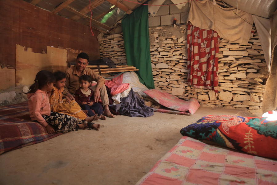 Waleed Al-Ahdal, 25, and his children in the family's shelter in a camp for internally displaced families in Yemen's Marib governorate. 