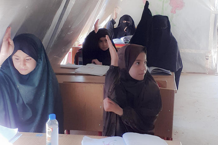 Girls attend class at a UNICEF-supported learning center in the Al-Hol camp for displaced families in northeast Syria in March 2022.