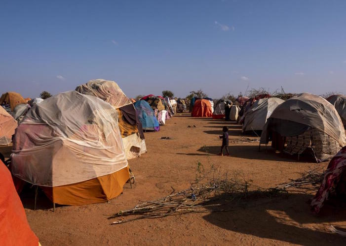 A child walks among tents at a site for internally displaced persons in Somalia, near the border with Ethiopia. 