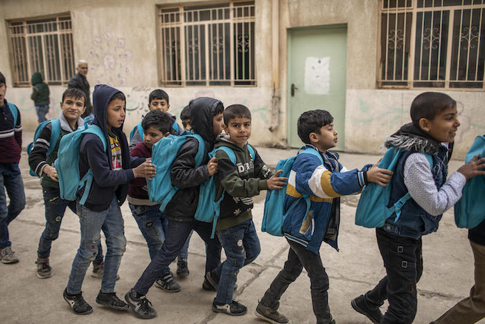On March 6, 2022 in Mosul, Iraq, students line up to return to class at UNICEF-supported Al-Hamideen School.