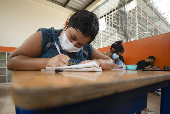  Romina, 14, performs a math exercise while attending classes at the El Giron school in Manta, Manabí, Ecuador, as part of a UNICEF-supported accelerated learning program. 