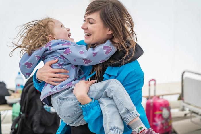 Emma, a 5-year-old refugee from Ukraine, plays with a UNICEF staff member at a UNICEF-UNHCR Blue Dot service hub in Romania, near the Isaccea border crossing.