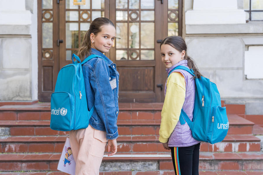 Students at a Bucharest primary school for newly arrived Ukrainian refugee children like Sofiya, left, and Liza received backpacks and supplies from UNICEF. 