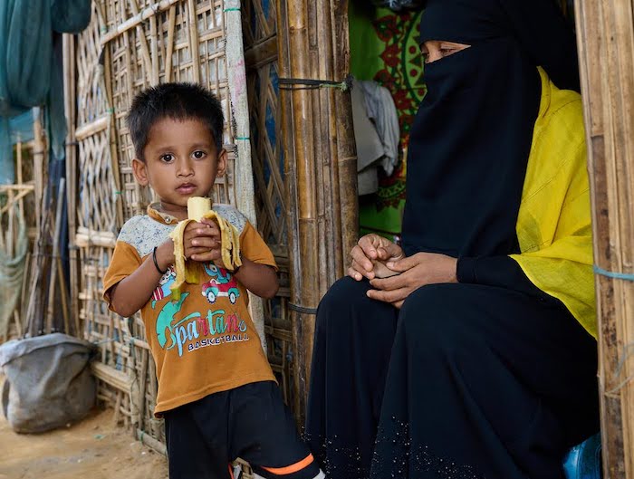 3-year-old Mohammed, a Rohingya refugee in Bangladesh who recently recovered from severe acute malnutrition after receiving treatment with UNICEF's support, enjoys a banana, his favorite food.