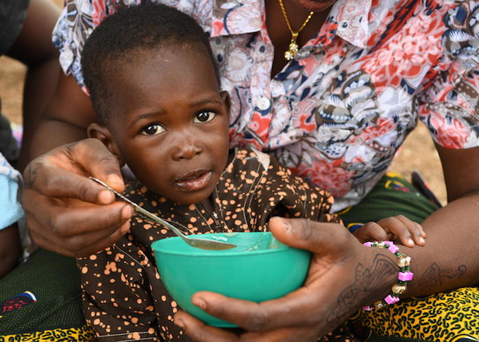 A mother and child attend at a malnutrition screening session in the village of Ngolo, in northern Burkina Faso.