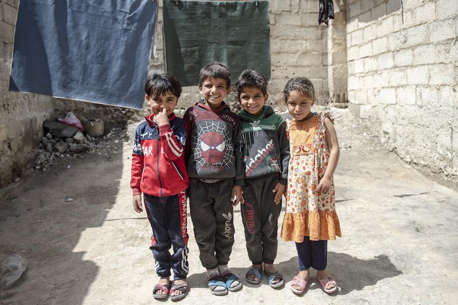 Hasan, 6, with his cousins Mohammad, 8, Ahmad, 7, and Sham, 6, in their neighbourhood in Kherbet Alward, Rural Damascus, Syria