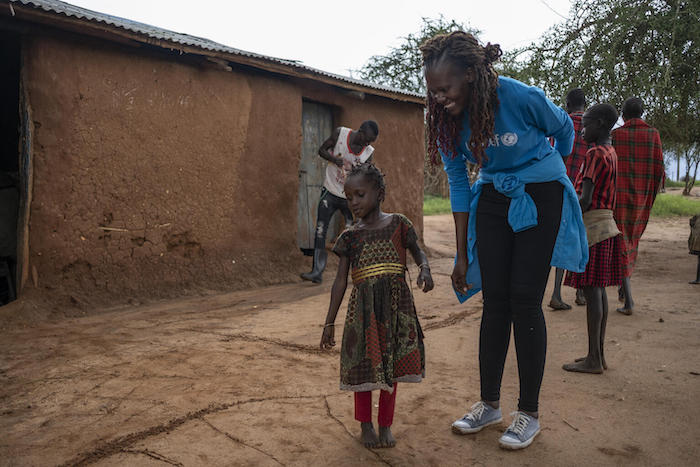 Rita Mwagale, Social Behavior Change Officer with UNICEF Uganda, greets a child from Kotirae village, Kakamar sub-county, Kaabong district.