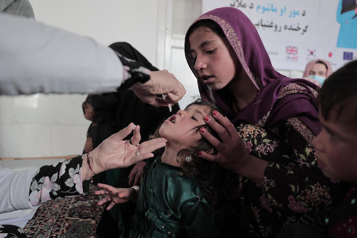 A boy receives an oral polio vaccine provided by a UNICEF-supported mobile health and nutrition team in Alisha village, Shak district, Wardak province, central Afghanistan.