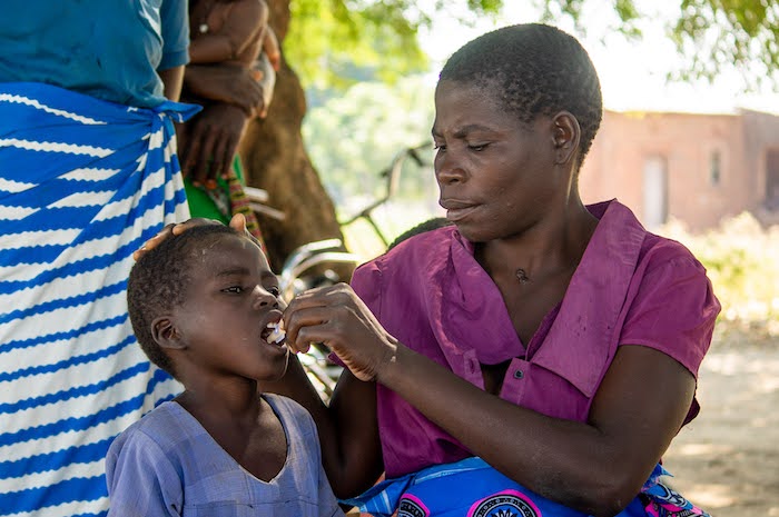 Mary Nafodi gives her 9-year-old daughter Alepha the oral vaccine for cholera during a UNICEF-supported emergency campaign in Misili village, Chikwawa district, Malawi.