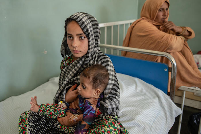 Zarghoneh, 9, cradles her baby brother at the UNICEF-supported Kunar Central Hospital, Afghanistan, where he is being treated for severe acute malnutrition.