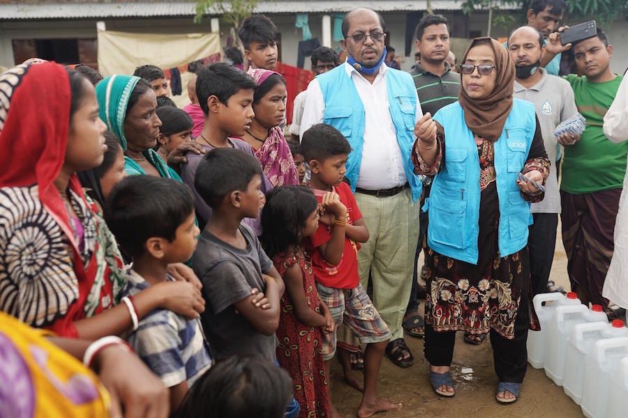 Kazi Dil Afroza Islam, UNICEF Chief of Field, teaches flood-affected families cut off from safe drinking water how to use water purification tablets in Sylhet, Bangladesh on June 21, 2022.