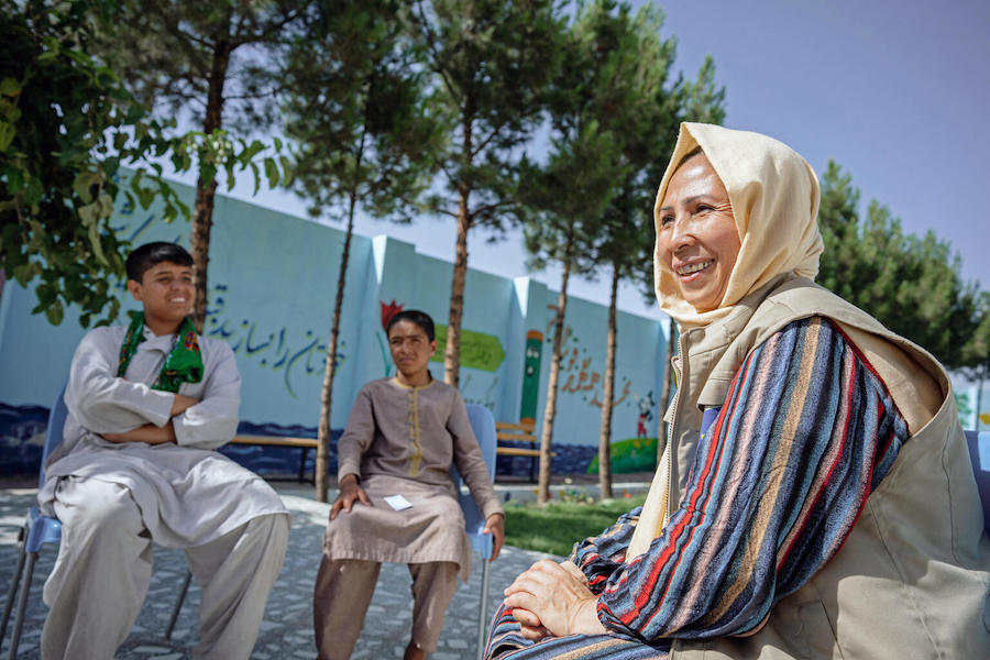 Mina Amiri, a psychosocial counsellor, meets with children at the UNICEF-supported Gazargah Transit Center in Herat, Afghanistan.