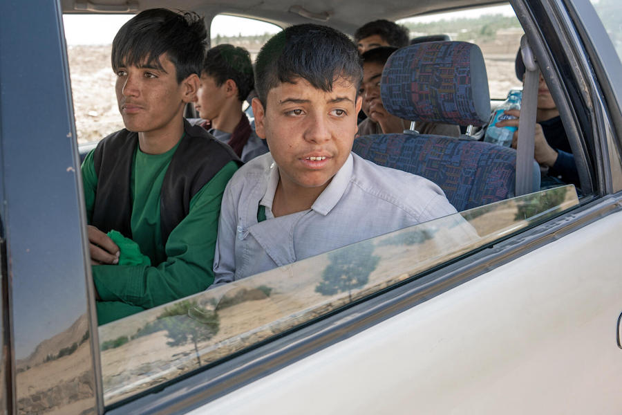 Thirteen-year-old Ashraf of Afghanistan is transported by van with other returning migrant children to the UNICEF-supported Gazargah Transit Center in Herat, where he will receive services.