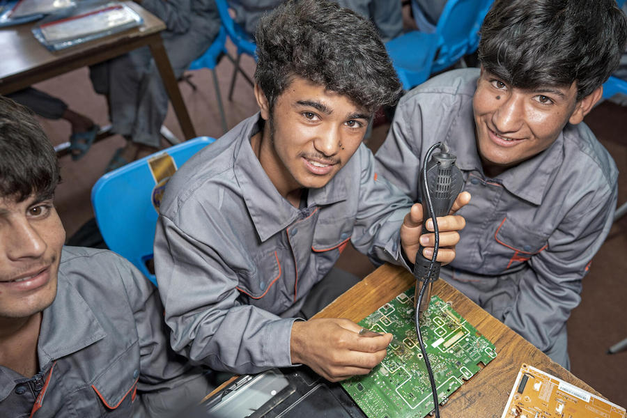 A 16-year-old trainee works on a circuit board alongside other adolescent boys at a UNICEF-supported vocational training center in Herat, Afghanistan.