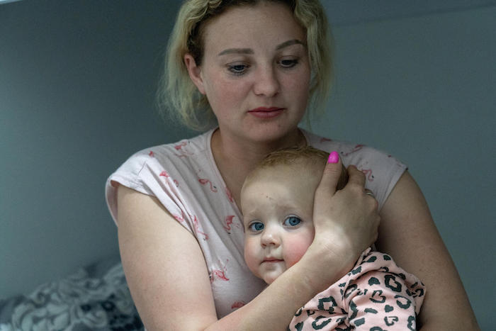 Mother of three from eastern Ukraine embraces her youngest child