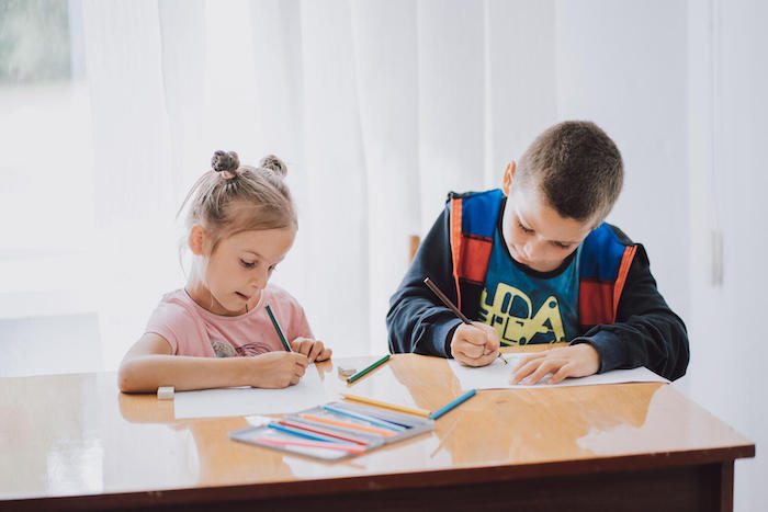 Two children coloring and learning mine safety through play in Ukraine