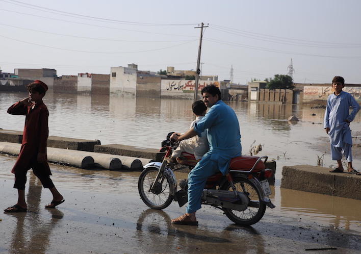 On Aug. 30,2022, people negotiate floodwaters in Khyber Pakhtunkhwa Province, Pakistan.