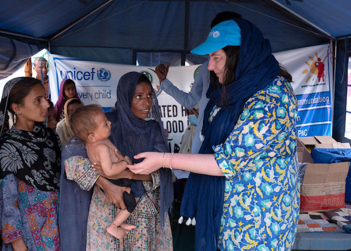 Catherine Weibel, UNICEF Chief of Advocacy and Communication in Pakistan, far right, speaks with Nazira, mother of three, at a mobile health unit in Balochistan, Pakistan. 