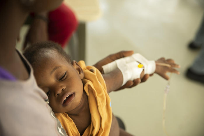 A young child being treated for cholera symptoms at UNICEF-supported Centres Gheskio in Port-au-Prince, Haiti, Oct. 14, 2022.