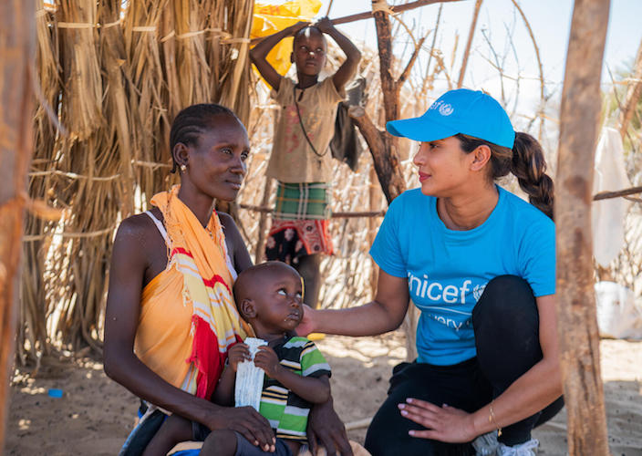 Priyanka Chopra Jonas, right, talks with Mary Apurot at her home in Nadoto Village, Turkana County, Kenya, after her 2-year-old son, Apolo Lokai, was screened for malnutrition.