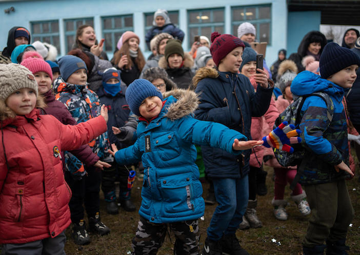Children dance at a holiday celebration in Balakiia, Ukraine, in December 2022.