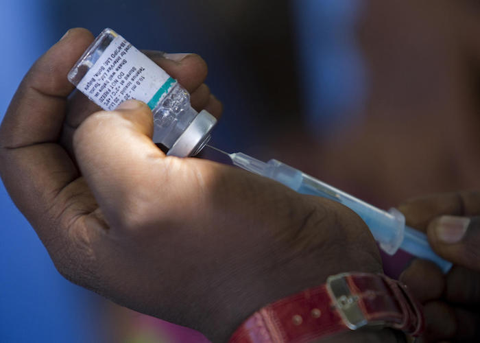 Nurse Emmanuel Kalwazi fills a syringe with tetanus toxoid vaccine provided by UNICEF. Kalwazi will use it to vaccinate a pregnant woman in Mukanga-Moke Village, Katanga Province, DRC. 