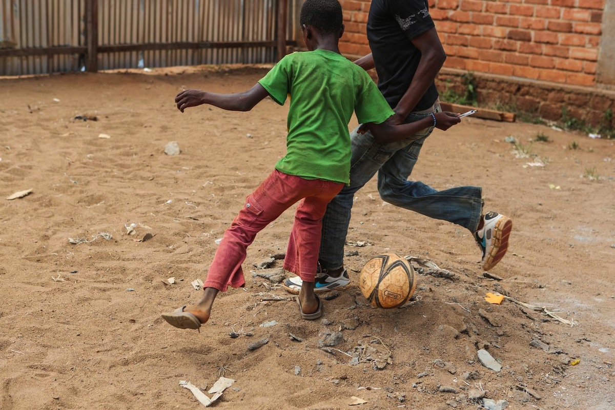 Children play football at a UNICEF-supported transit center for recently released former child soldiers.