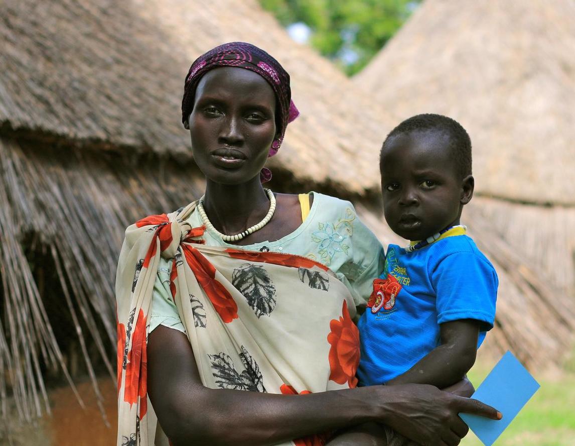 Nyalyauk Nyok, holding 3-year-old Gatluak Wiyual in Kiech Kon , South Sudan, where UNICEF and partners are assisting people affected by the conflict.