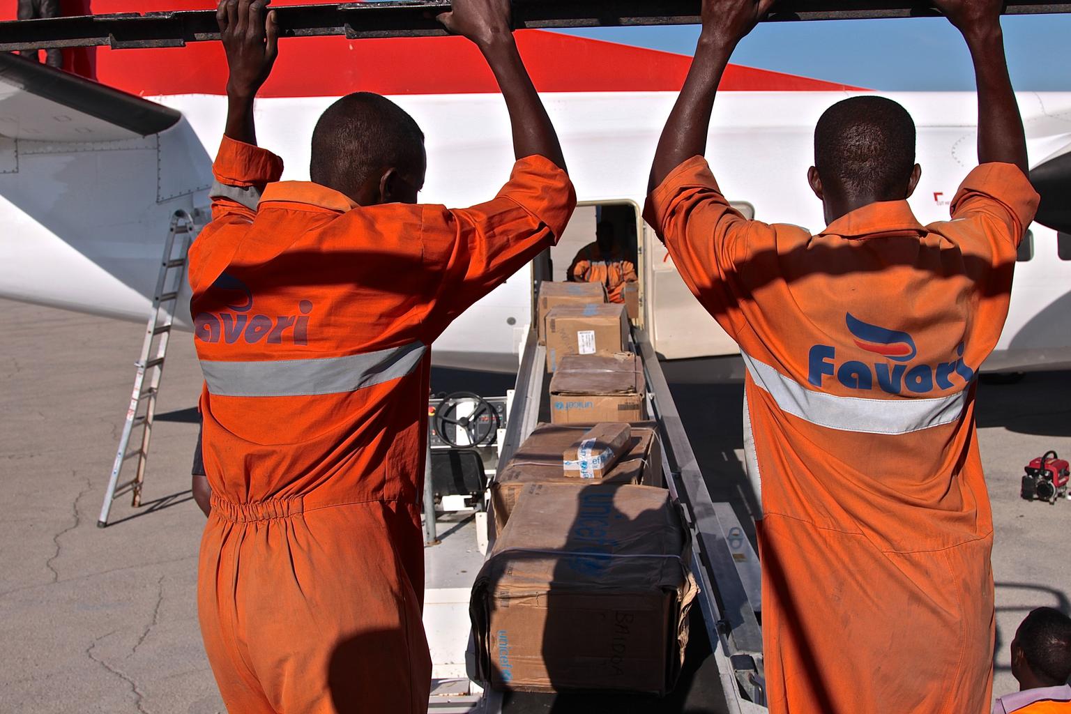 Workers load polio and measles vaccines along with medicine and therapeutic food onto a plane in Mogadishu, Somalia, for transport to those previously cut off from humanitarian aid.  After a May 2014 measles outbreak, UNICEF piggybacked an emergency vacci