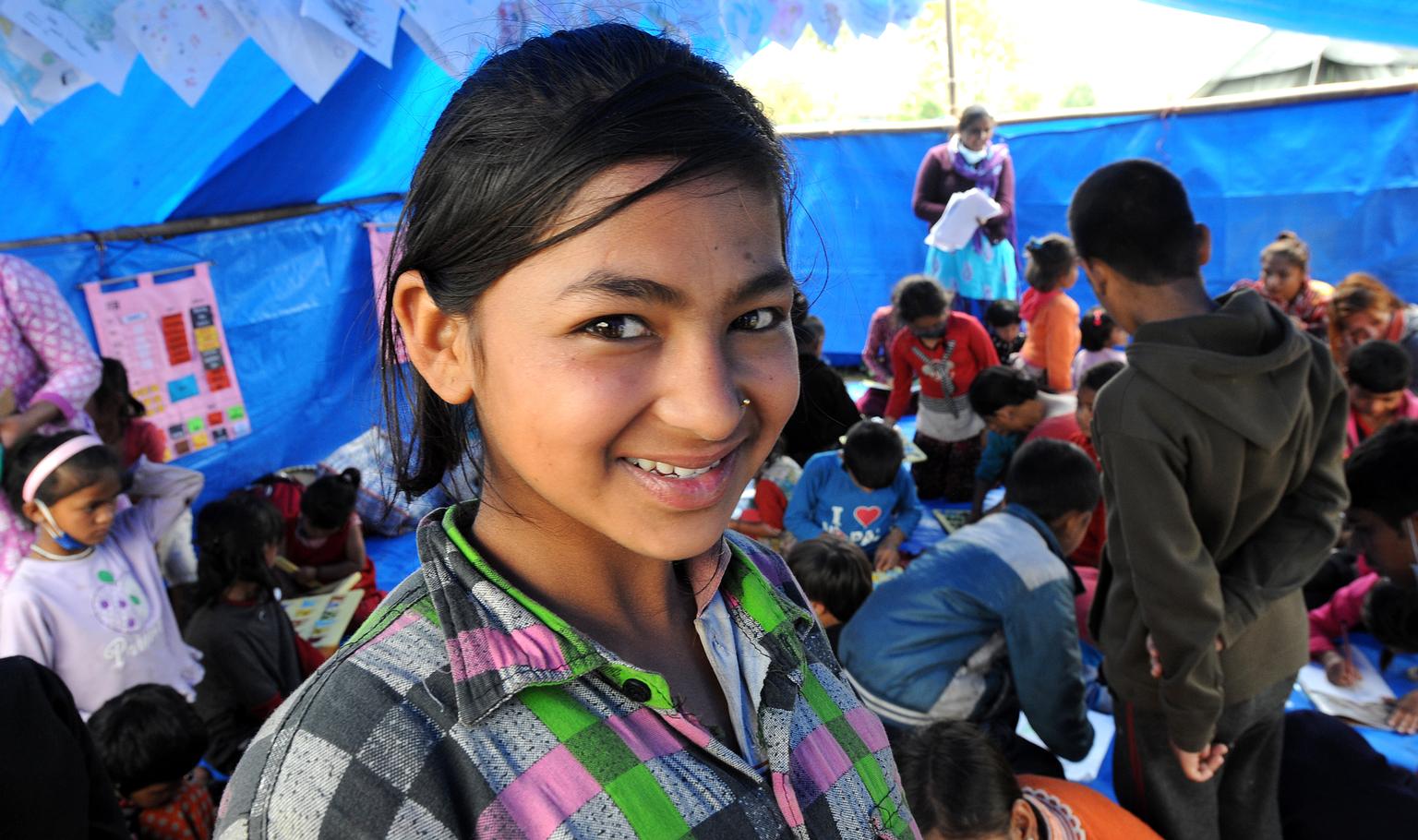 Sarita, 13, stands in a tent housing a UNICEF-supported child-friendly space in Tundikhel. © UNICEF/NYHQ2015-1088/Karki