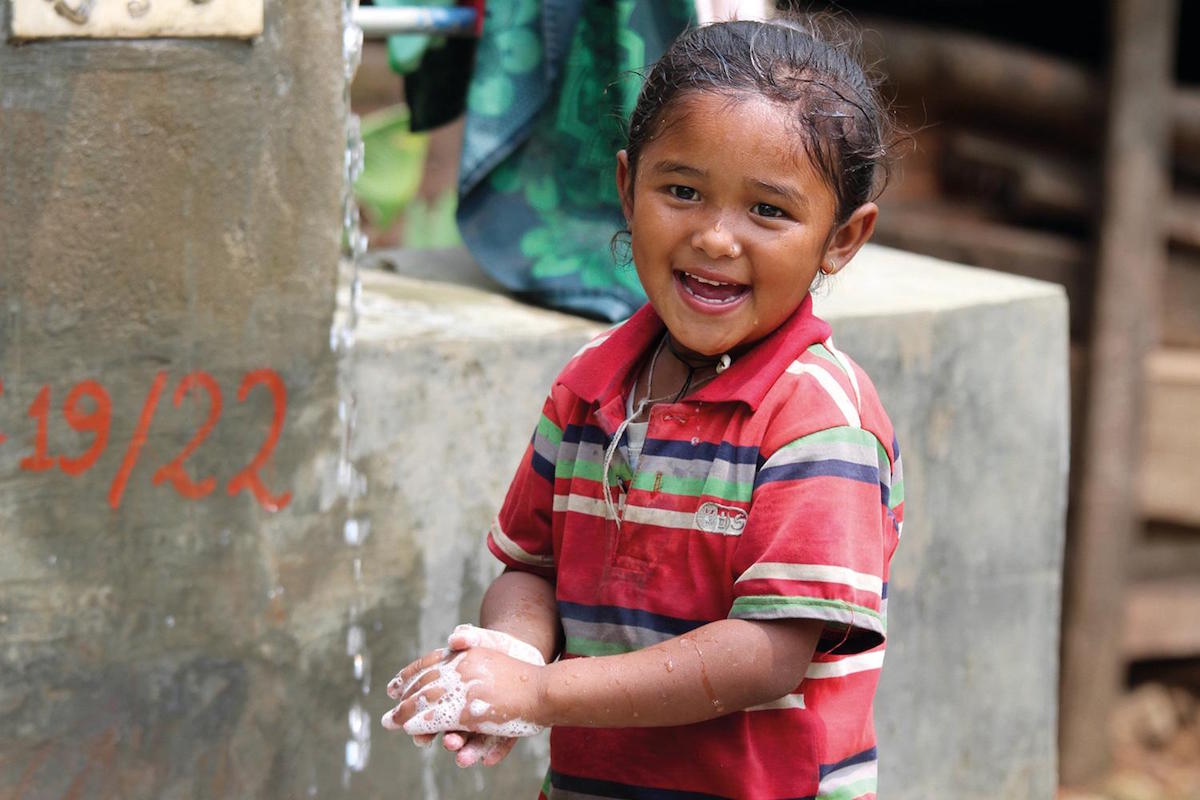 On 8 May 2015, a young girl washes her hands with soap included in UNICEF-provided hygiene kit in Baluwa village in Gorkha district, Nepal.