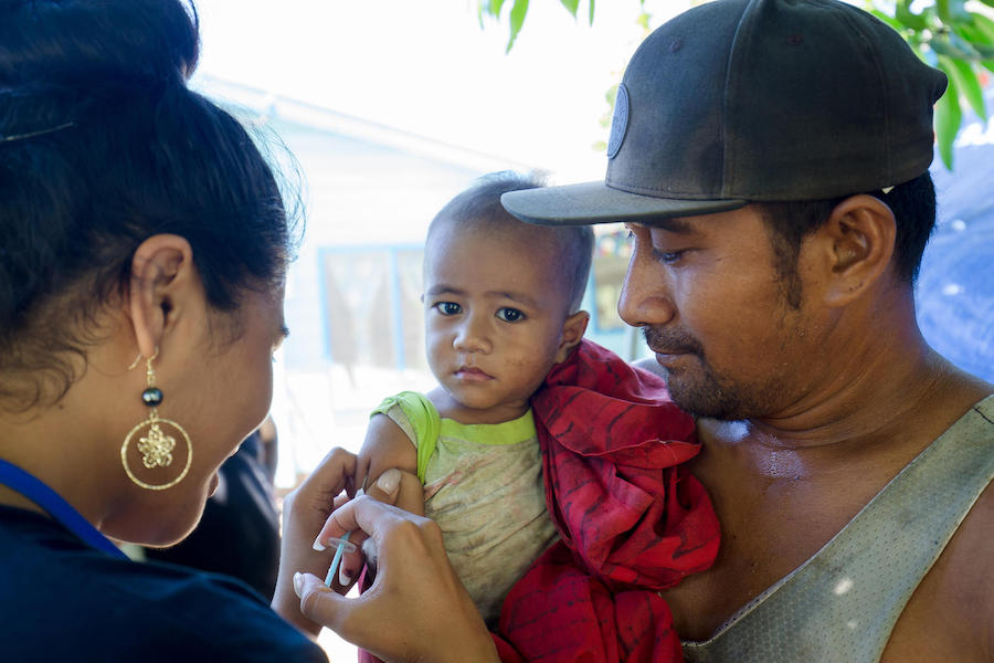 Miss Pacific Islands 2019/Miss Samoa, Fonoifafo McFarland-Seumanu administers a measles vaccine to one-year-old Sugalu in Vaitele, during a UNICEF-supported National Vaccination Campaign in response to the current measles outbreak in the Pacific region.