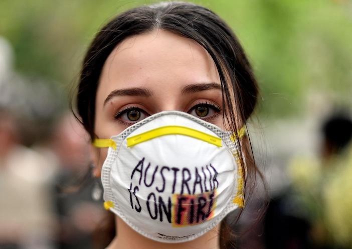 A demonstrator with a mask attends a climate protest rally in Sydney, Australia on December 11, 2019. Up to 20,000 protestors rallied to demand urgent climate action from Australia's government as bushfire smoke choked the city, causing health problems.