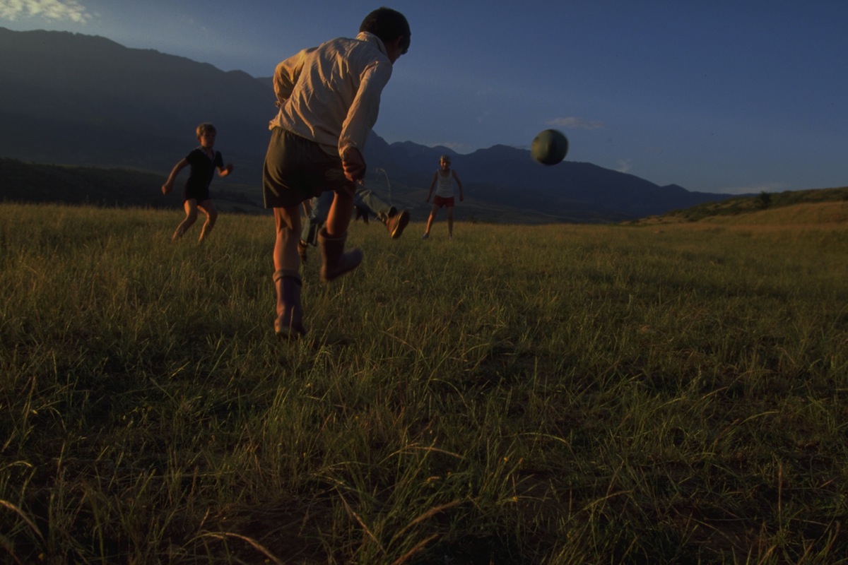 Boys play soccer in a field used for play by refugees from Kosovo in 1998, near the town of Bajram Curri, Albania.