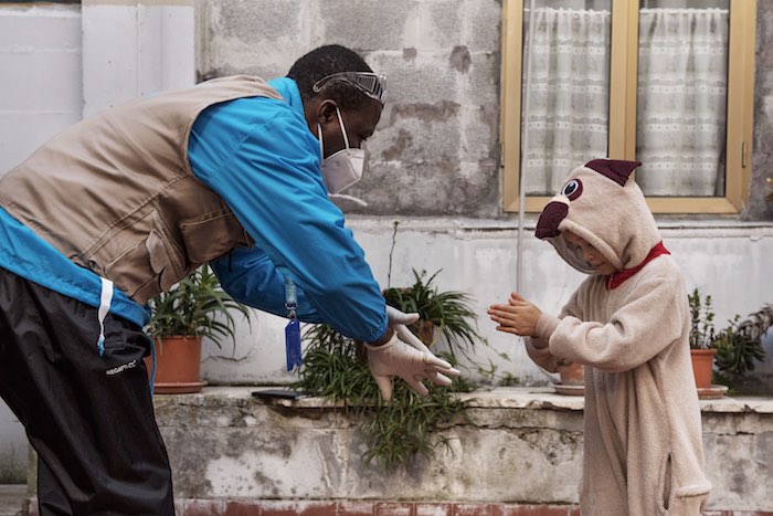 On 31 March 2020, seven-year-old Francesca [NAME CHANGED] is taught how to correctly wash her hands by INTERSOS/UNICEF outreach worker Abdoul Bassite in the informal settlement in Rome, Italy, where she lives.