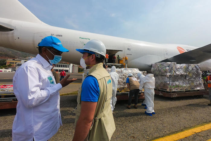 UNICEF Venezuela Representative, Herve Ludovic de Lys, and Alejandro Caldoni, Supply and Logistic Assistant, at runway at Maiquetia airport on April 8,2020.