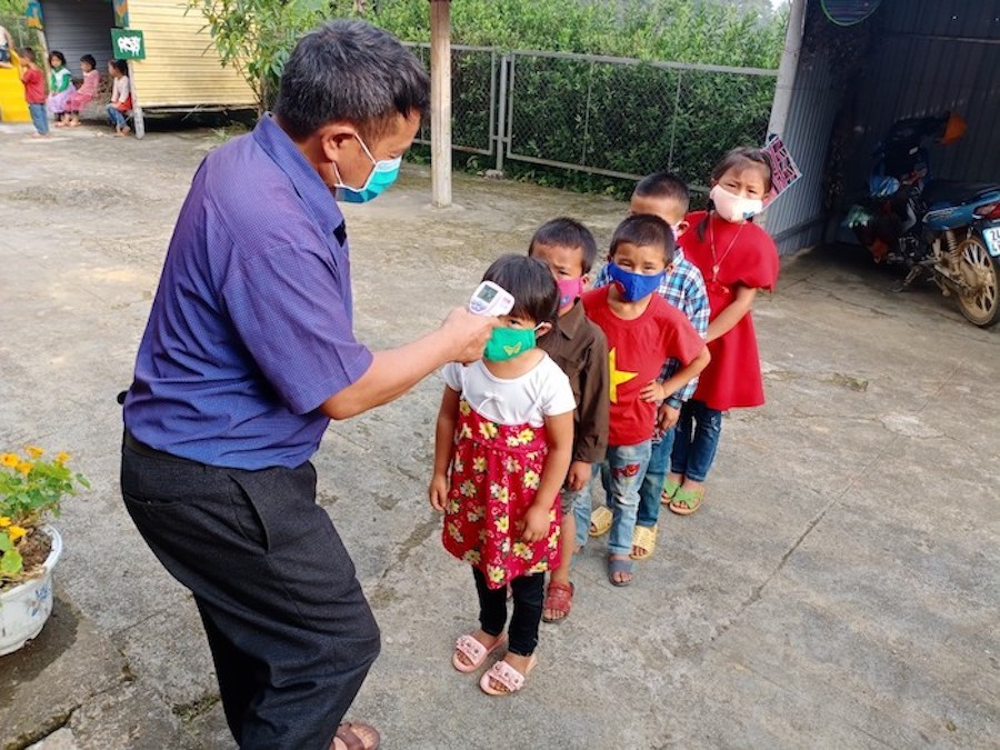 Routine temperature checks and other COVID-19 preventive measures are in place to support students' return to school in Lao Cai, Vietnam.