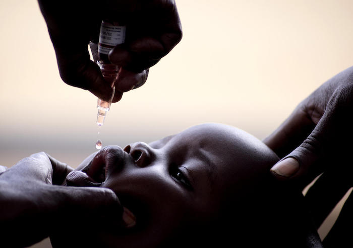 A baby receives polio vaccine at Jupanziri Health Center III in Uganda's Nebbi district as part of a UNICEF-supported national mass vaccination campaign. 