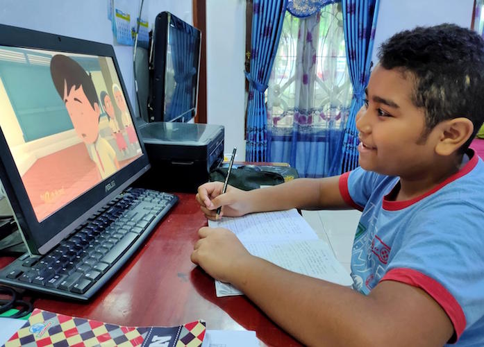 Joaquin, 8, participates in an online learning activity at home in Jayapura, Indonesia, after his school was closed to prevent the spread of COVID-19.