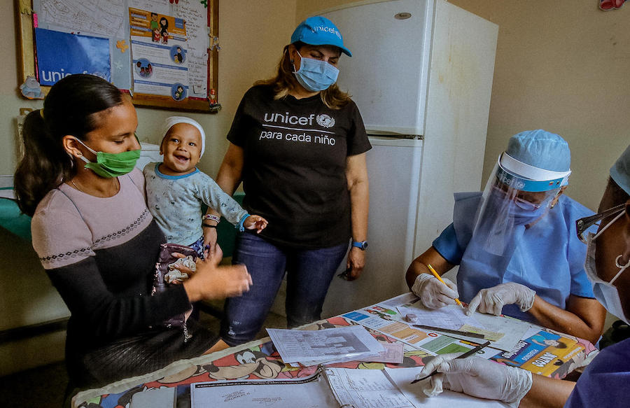 A mother and her baby receive services at a UNICEF-supported health facility in Bolivar state, Venezuela. A mother and her baby receive services at a UNICEF-supported health facility in Bolivar state, Venezuela.