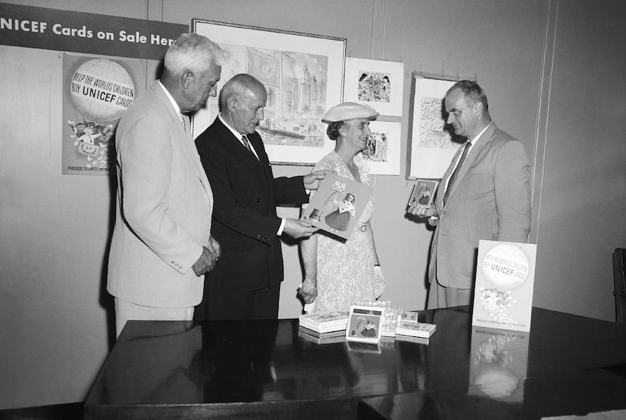 UNICEF Executive Director Maurice Pate and Prime Minister of Australia Robert Menzies, Mrs. Menzies and E.J.R. (Dick) Heyward review the 1958 selection of UNICEF greeting cards.