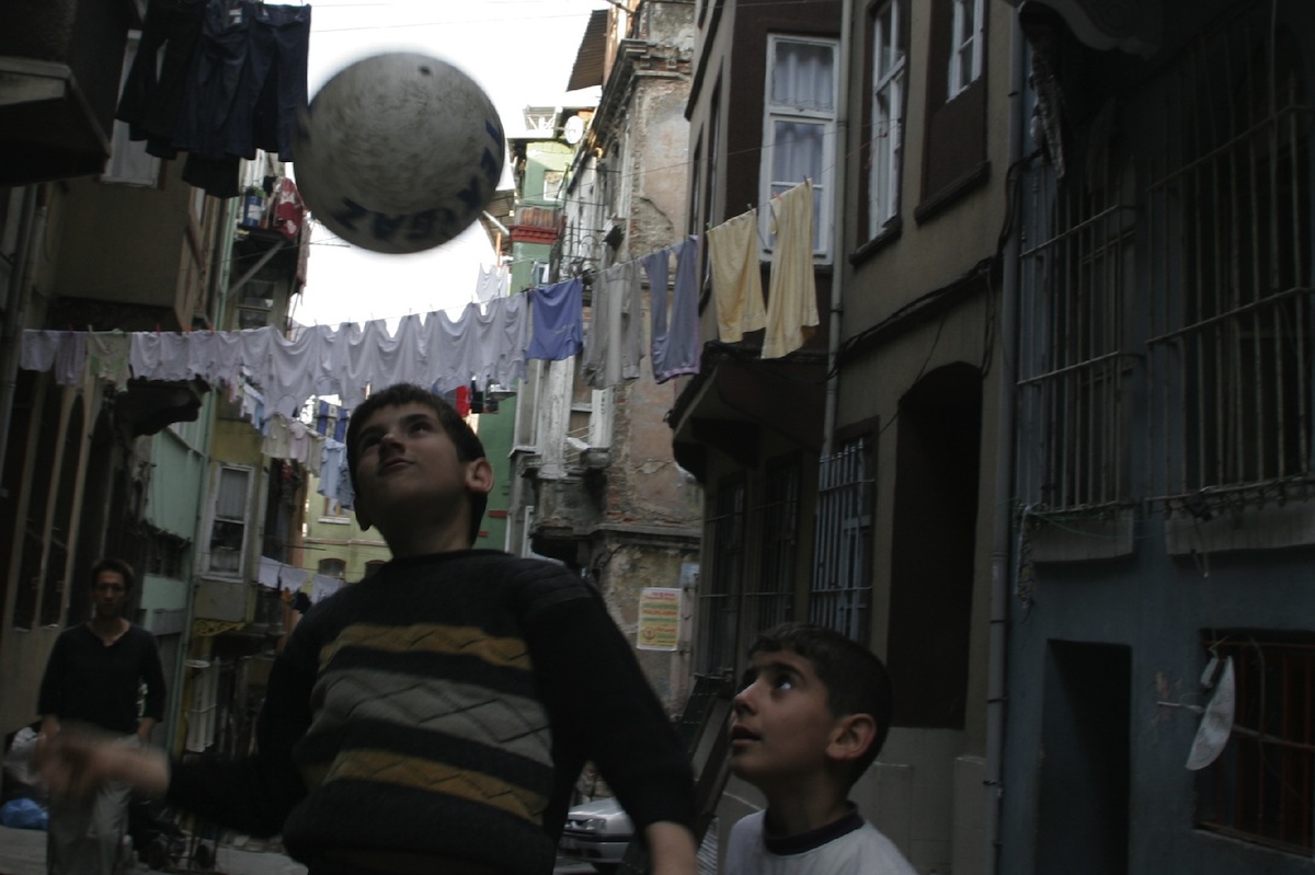 Boys play football on the streets of Tarlabasi, a relatively poor section of the city of Istanbul.